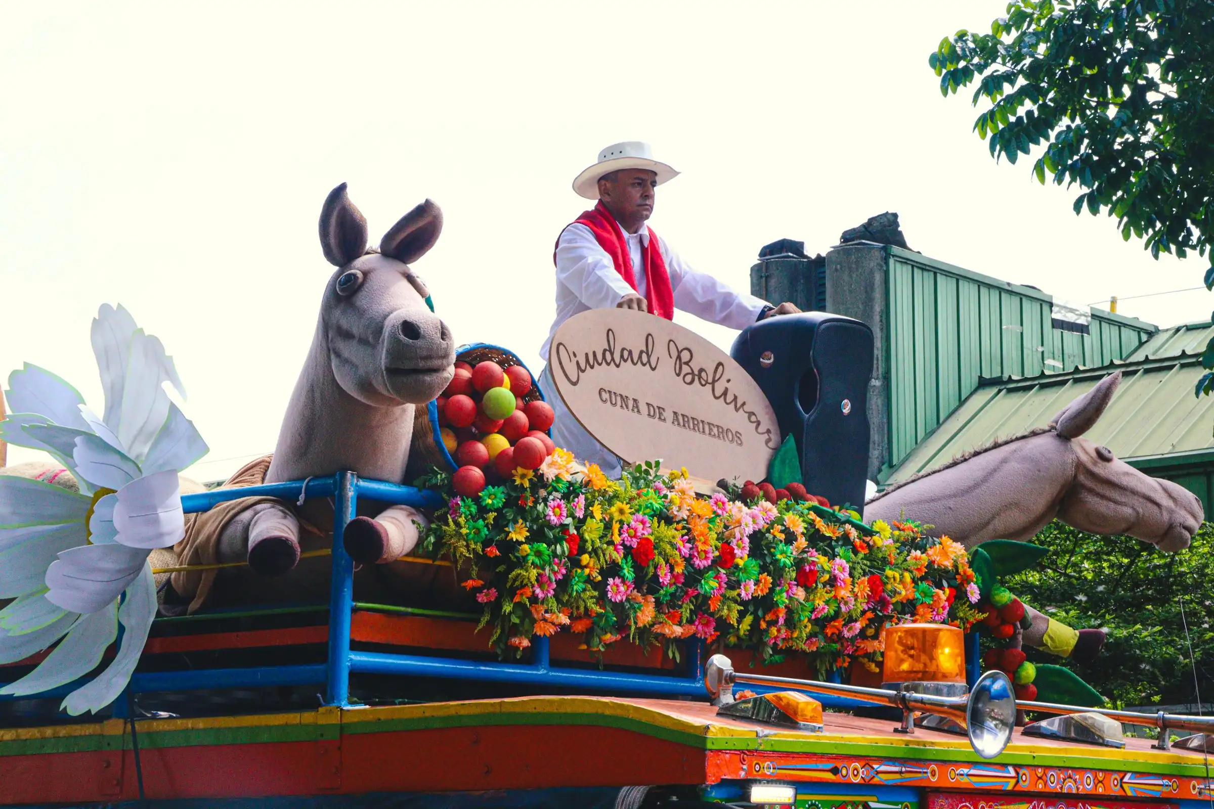 A float decorated with flowers and horse figures in the parade at Medellín's Flower Festival