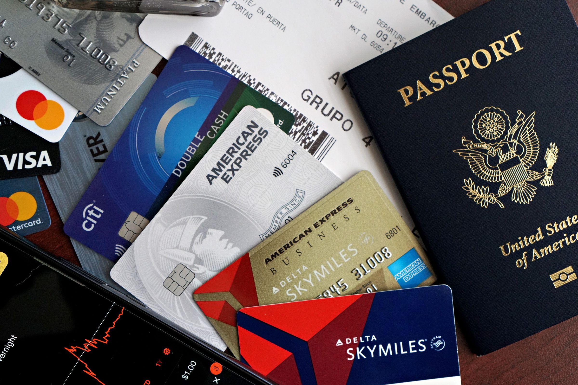 A passport, several credit cards and a boarding pass on a table
